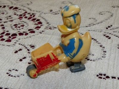   1950s disney plastic ramp walker donald duck pushing a wheelbarrow