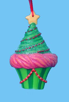 Cupcake is shaped like a Christmas tree, lightly dusted with glittery 